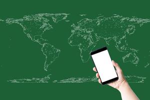 Hand holding smartphone and white screen on world map and green background. Business, technology, learning, and travel concept.