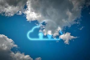 Cloud data storage concept. White cloud and arrow on blue sky background with copyspace. Communication of business and financial. Transfer data to storage. photo