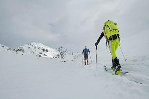 Couple of mountaineers with skis during a trip photo