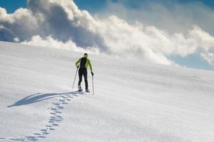 Man with snowshoes on snow photo