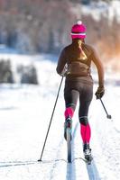 Cross-country skiing of a young athlete girl. Classical alternating technique photo