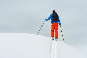 A top the mountain alone with ski mountaineering photo