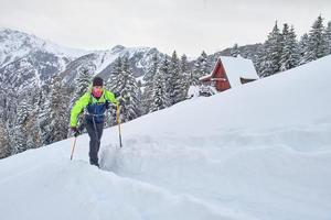 Young man in action on climbing touring skis photo