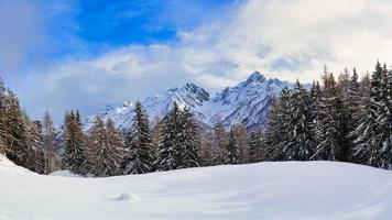 Winter landscape panorama between woods and mountains photo