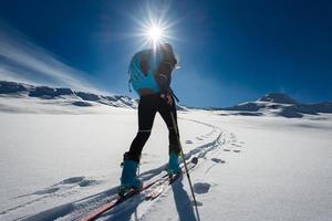 Ascent with ski mountaineering and climbing skins for a single woman photo