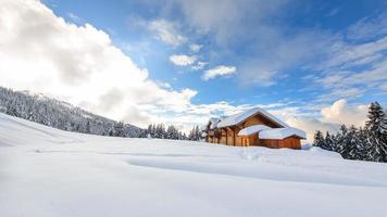 Alpine hut in the midst of lots of snow on the Italian Alps photo