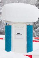 Mobile toilet covered in snow photo