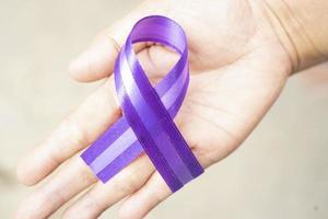 Purple ribbon for world cancer day photo background