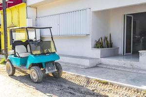 Golf cart buggy cars carts muddy street village Holbox Mexico. photo