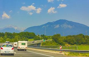 Driving on highway to Kranj Slovenia with mountain range panorama.