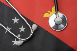 Papua new Guinea flag and stethoscope. The concept of medicine.