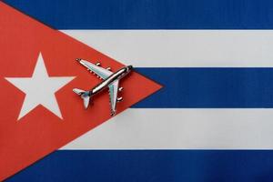 Plane over the flag of Cuba, the concept of travel. photo