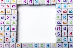 Many colorful decorative cubes with letters on a white background. photo