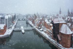 Medieval port crane in Gdansk over the Motlawa river at snowy winter, Poland photo