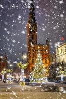 Beautiful Christmas tree in the old town of Gdansk at snowy night. Poland photo