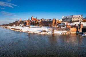 Granaries of Grudziadz city reflected in the Vistula river at snowy winter. Poland photo