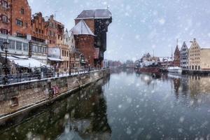 Medieval port crane in Gdansk over the Motlawa river at snowy winter, Poland photo