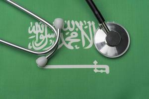 Saudi flag and stethoscope. The concept of medicine. photo