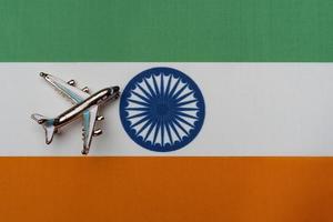 Plane over the flag of India, the concept of journey. photo