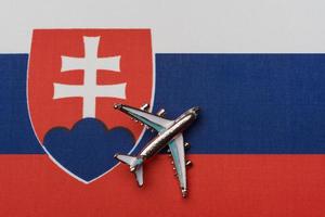 Airplane over the flag of Slovakia, the concept of travel. photo