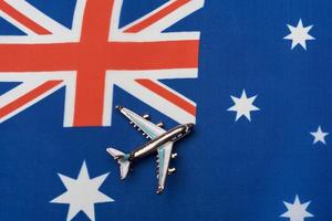 Plane over the flag of Australia, concept of travel.