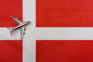 Plane over Denmark flag travel concept. photo