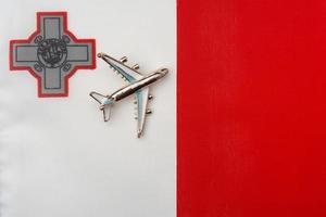 avión sobre la bandera de malta el concepto de viajes y turismo. foto