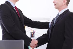 Successful business partnership concept with businessmans handshake at office background. Team work businessmen handshaking after profitable deal. Selective focus. Banner and copy space photo