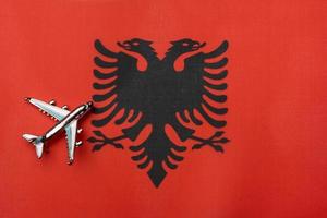 The plane over the flag of Albania, the concept of travel. photo