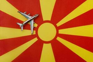 Plane over the flag of Macedonia concept of travel and tourism. photo