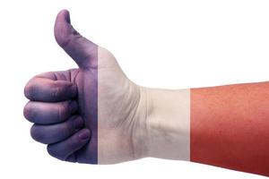 el concepto de francia: la mano da un pulgar hacia arriba con la bandera de francia. foto