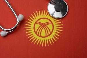 Flag of Kyrgyzstan and stethoscope. The concept of medicine. photo