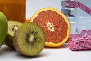 Refreshing ice water with kiwi and grapefruit on white background. photo