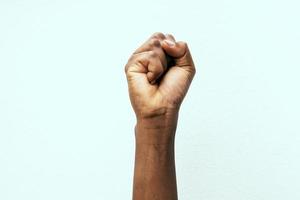 black fist in the air as a sign of power photo