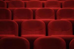 Empty cinema hall with red seats. Movie theater.