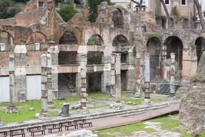 Many benches and ruins near them in the city of Rome. photo