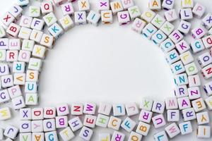 Many colorful decorative cubes with letters on a white background. photo