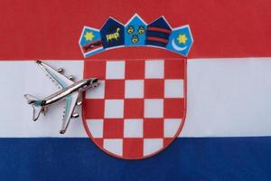 Plane over the flag of Croatia travel concept. photo