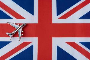 The plane over the flag of great Britain, the concept of travel. photo