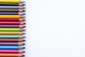 Colored pencils on a white background close-up. photo