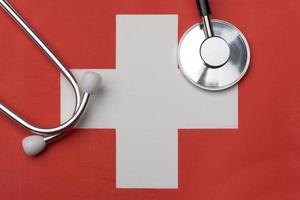 Swiss flag and stethoscope. The concept of medicine. photo