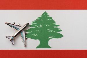 The plane over the flag of Lebanon, the concept of travel. photo