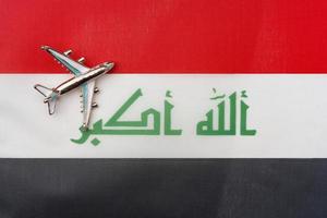 Aircraft over the flag of Iraq travel and tourism concept. photo