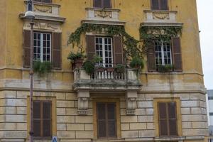 Windows and balcony of an old house in Italy. photo