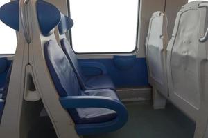 Inside the cab of the modern Express. Nobody in blue chairs by the window. Fuzziness. Comfortable chairs and table in the foreground, white background outside the window. photo