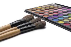 Makeup brushes and eye shadow, on white isolated background. photo