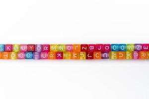 Many colorful decorative cubes with letters on a white background. photo