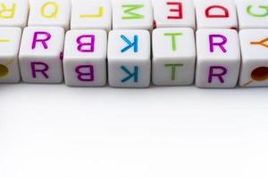 Many colorful decorative cubes with letters on a white background. photo