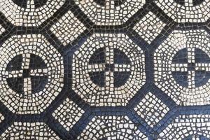 Mosaic on the floor in the shape of a cross. photo
