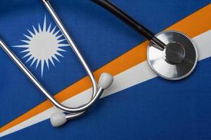 Marshall Islands flag and stethoscope. The concept of medicine.